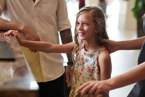 A minor girl with her parents