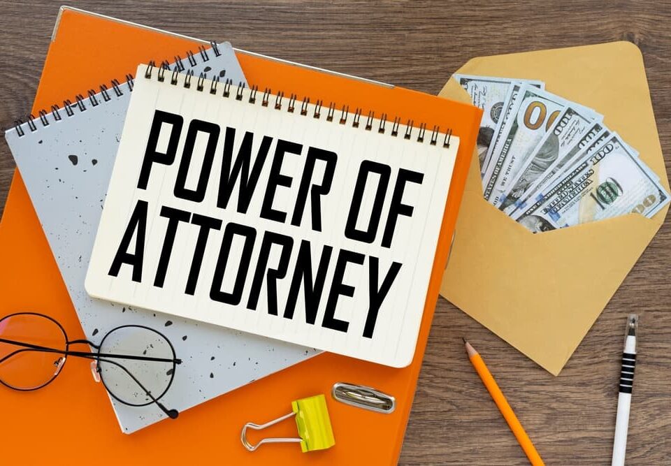 power of attorney top view of text on notepad and money bills in envelope