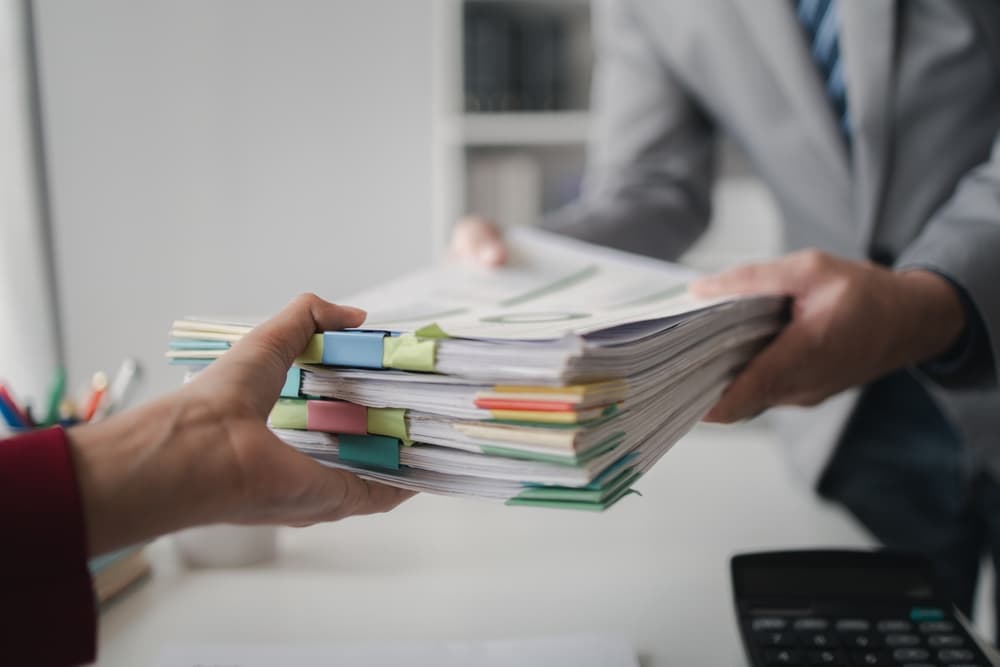 A person handing over probate papers to another man