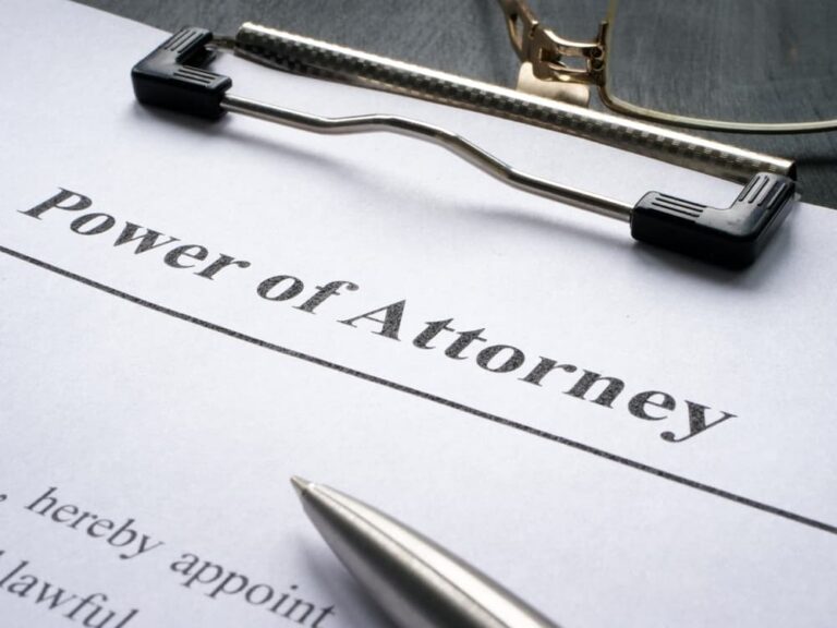 Power of Attorney form in clipboard and pen