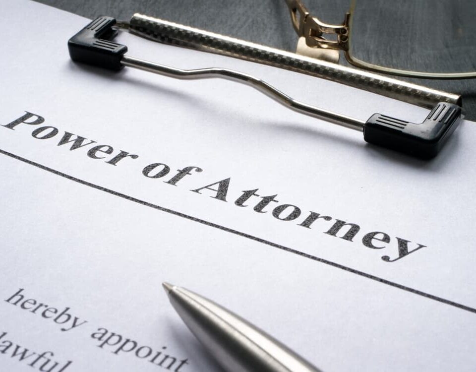 Power of Attorney form in clipboard and pen