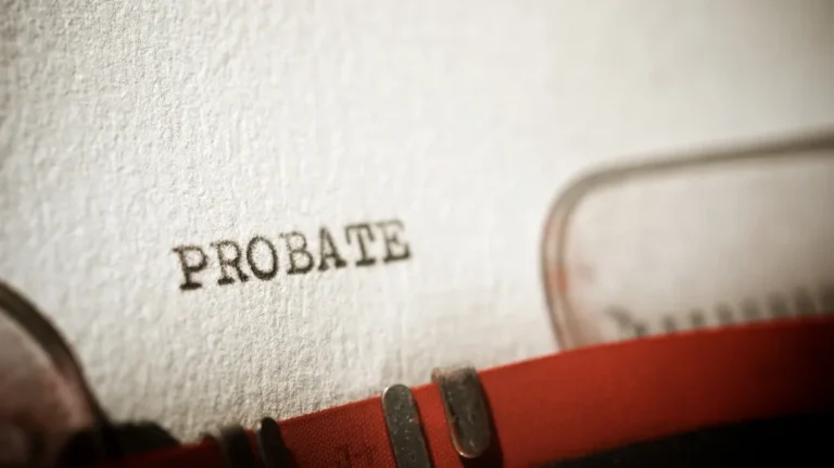 Close-up of a typewriter printing the word "PROBATE" on textured white paper.
